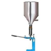 Polished Manual Henna Paste Filling Machine, Filler Machine | Liquid Paste Filling Machine | Bottle Filler Machine for Cosmetic Capacity: 10 Kg Approx Used for Making Cones
